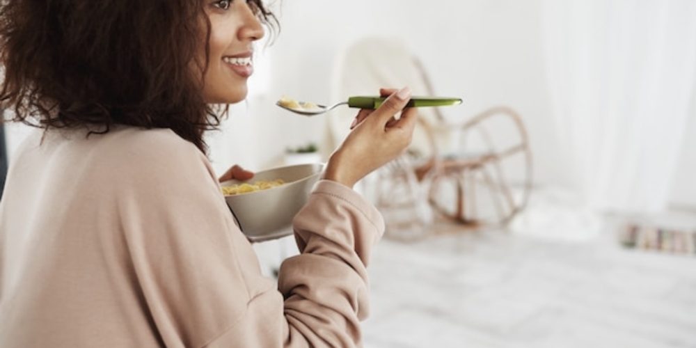 A woman eating mindfully in soft light