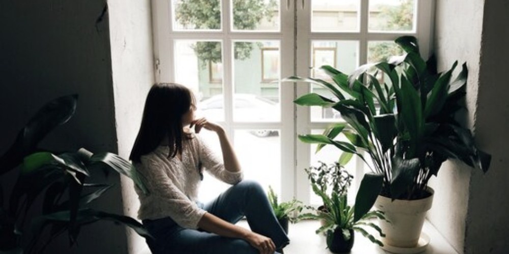 A woman pausing thoughtfully in a quiet moment of self-reflection
