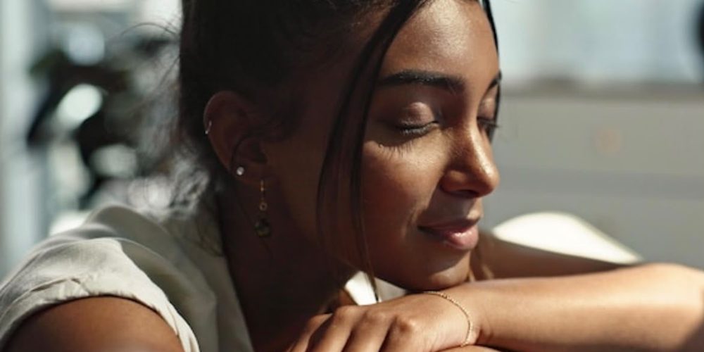 A woman resting peacefully with her eyes closed