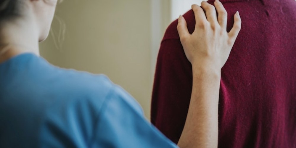 A person resting a hand over their chest, breathing slowly
