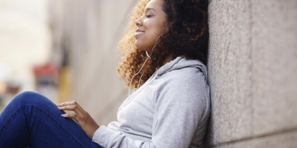 A person pausing for a quiet, reflective moment by a window